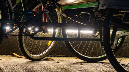 backlight photo art of the bottom of a parked pedicab with artistic lighting