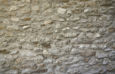 Very old brick stone wall of castle or fortress of 18th century. Full frame wall with obsolete dirty and cracked bricks close up