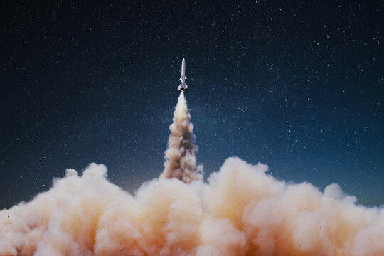 Launching a rocket with clouds of smoke in the starry sky at night. War and missiles weapons. Weapon Rocket successfully takes off into the sky
