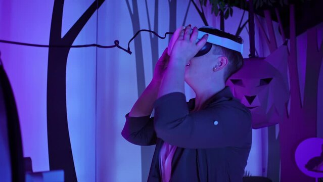 Young woman enjoying immersive multimedia experience using virtual reality glasses in a natural history museum playroom, close up handheld shot.