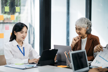 Fototapeta premium Group of Young Asian business team creative businesspeople coworker in office. Meeting Presentation for analysis graph company financial. People Work in Business Office.