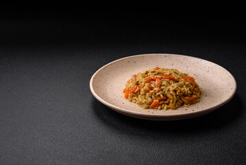 Delicious Uzbek pilaf with chicken, carrots, barberry, spices and herbs