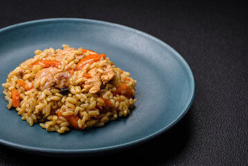 Delicious Uzbek pilaf with chicken, carrots, barberry, spices and herbs
