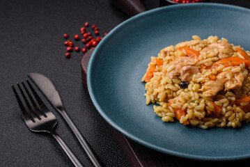 Delicious Uzbek pilaf with chicken, carrots, barberry, spices and herbs