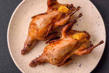 Roasted quail, partridge or pigeon stuffed with orange with spices and herbs