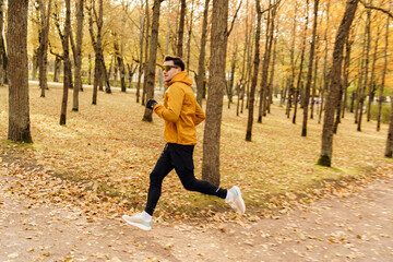 Fitness day in winter and autumn beautiful colors. Jogging is a hobby and cardio training for a young person to burn calories.