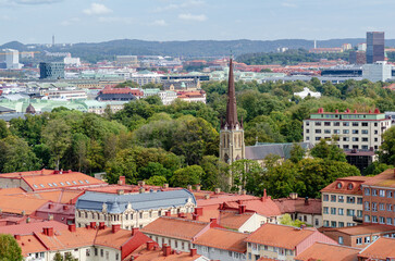 Fototapeta na wymiar Aerial view of the Haga church (Hagakyrkan) in Gothenburg, Sweden surrounded by red rooftops and green trees