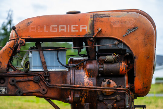Lyngdal, Norway - June 27 2023: Vintage orange Allgaier Porsche tractor in a field.