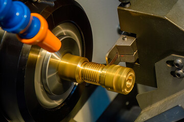 Close up scene the CNC lathe machine slot cutting at the end of brass pipe coupling parts.