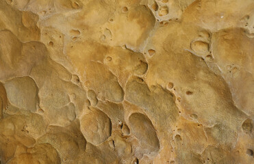Combination of stone relief like a orange planet surface. Brown stone with abnormal relief shape with specific light