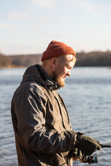 fisherman fishing on the river bank, Fishing rod, spinning