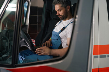Automotive technician performing computer diagnostic test on client vehicle
