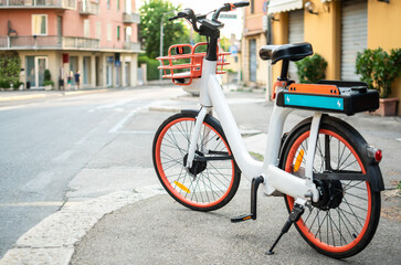 Fototapeta na wymiar Electric bike for rent parked on street for eco use by mobile phone application