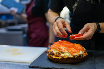 chef hand cooking big large cheese burger on restaurant kitchen. step by step
