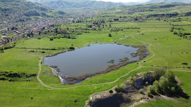Small lake in village drone video