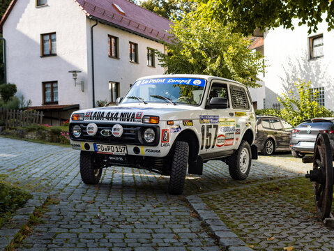 GÖSSWEINSTEIN, GERMANY - 31. August 2023: Lada Niva 4x4 Paris Dakar rallye car parking in the town. The offroad racing car is built for motorsport purpose.