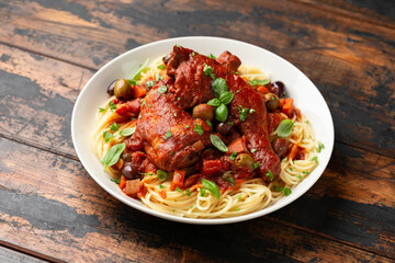 Cacciatore Chicken with spaghetti, vegetables, olives and tomatoes