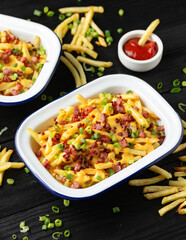 Crispy French fries loaded with bacon, cheese sauce and spring onion
