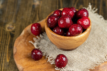 covered with drops of water ripe red cherries on the table