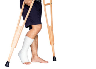 Close-up patient with broken leg in cast and bandage, man with leg splint is walking support with...