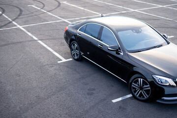 Luxury black car on a parking lot, view from above. Business transfer serfice concept and...