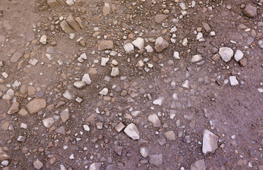 Background of shattered stony stones surface in mountain area. Flat texture with natural light
