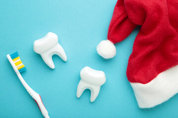 White teeth with santa hats on blue background. Dentist Merry Christmas and New Year concept.