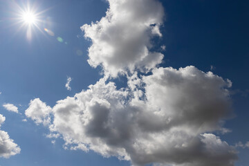sunny weather with white clouds on a blue sky background