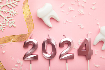 Figure 2024 and tooth with Christmas decoration on pink background