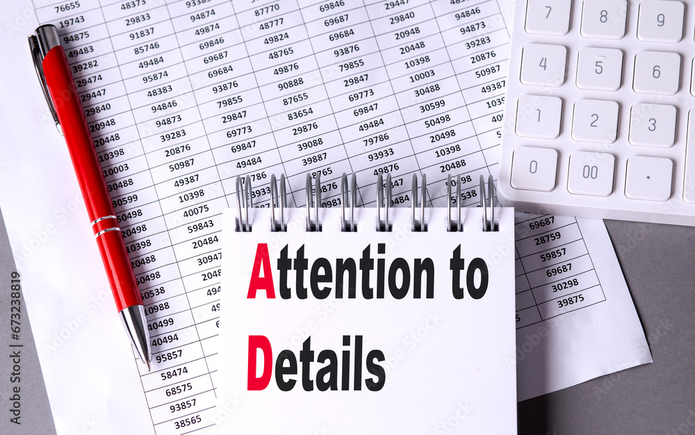 Poster attention to details text on notebook with pen, calculator and chart on grey background