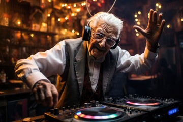 A senior male DJ, with a head of silver hair, dons headphones while playing music at the nighttime...