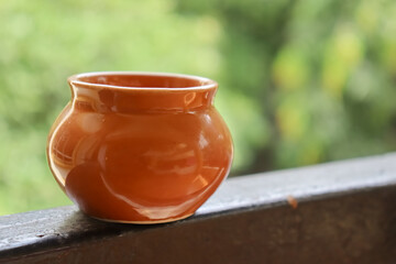 brown ceramic small matka with blurred background