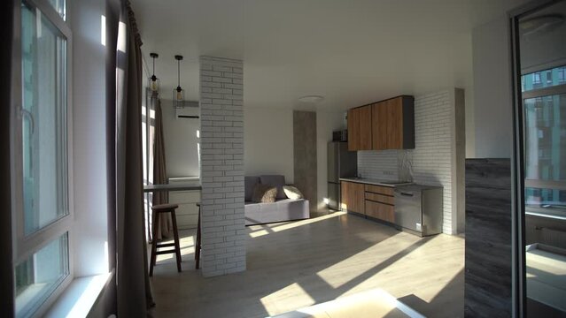 Modern small room with kitchen area and wooden floor