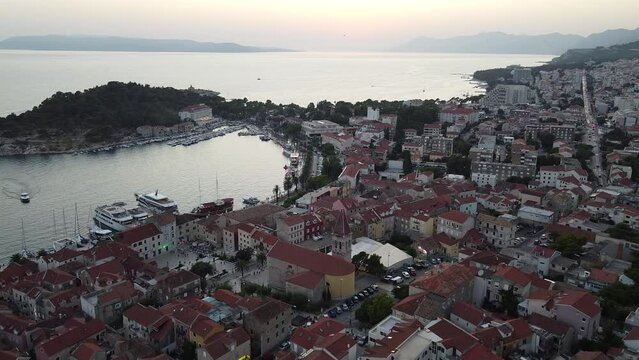 Panorama of the sunset city of Makarska Croatia drone video