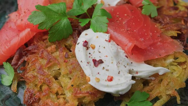 Potato rosti with smoked salmon and soft cheese. Rotating video