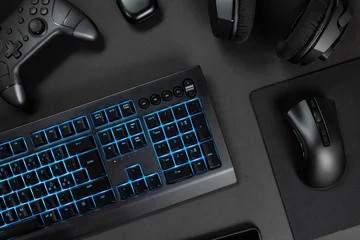 Fotobehang Blue lit keyboard by various wireless gadgets © kjekol