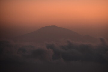 Orange sky at a stunning sunset above the clouds on Mount Kilimanjaro in Tanzania, Africa