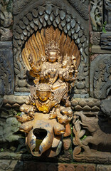 Vishnu God and Laxmi Goddesses gold couple statue statue in Patan Durbar Square royal medieval palace and UNESCO World Heritage Site. Lalitpur, Nepal.