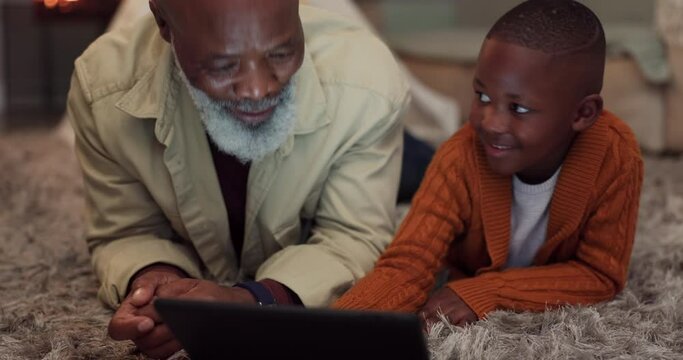 Kid, learning and grandfather with tablet in home with mobile app, education and time relax together in living room. African, senior man and teaching family with technology or bonding with games