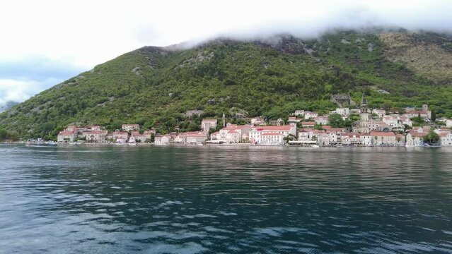 A scenic view of the town of Perast and surrounding mountains from the Bay of Kotor, Montenegro