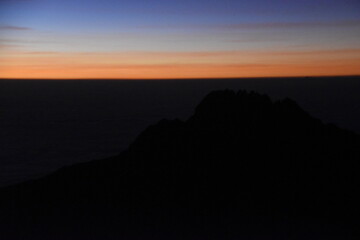Orange sky at a beautiful sunset above the clouds on Mount Kilimanjaro in Tanzania, Africa
