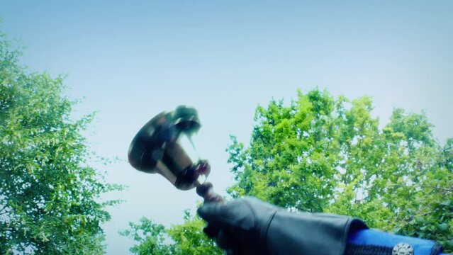 Hand Bell Is Rung Outside By Trees
