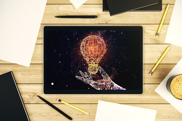 Creative light bulb hologram on modern digital tablet screen, idea concept. Top view. 3D Rendering