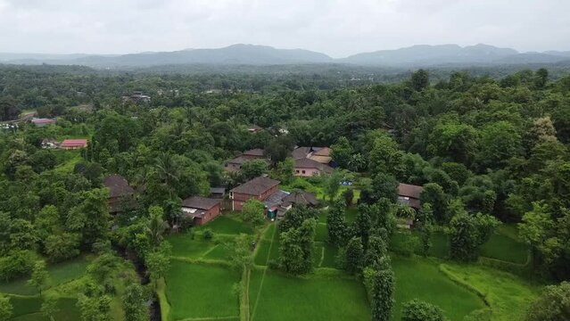 Drone footage over the houses in Nature Village on a cloudy day in Ratnagiri, Maharashtra, India