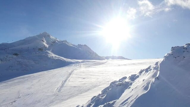 Skiing on Winter ski resort in the Austrian Alps. Hintertuxer glacier. Winter scenery of sun, snow and skiers.