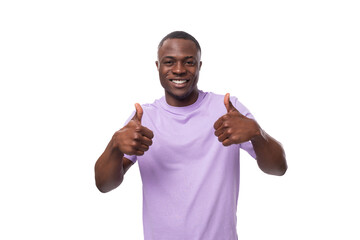 young positive american man in a lilac t-shirt is inspired by an idea and success on a white background