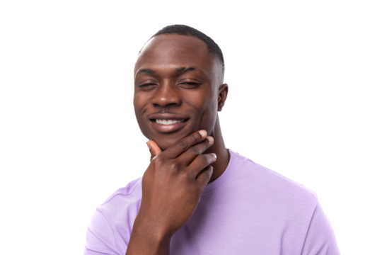 young serious well-groomed american guy dressed in a cotton t-shirt on a white background with copy space