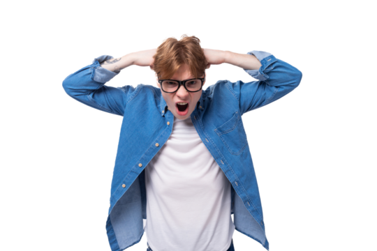 young joyful surprised red-haired guy dressed in a blue shirt wears glasses on a white background with copy space