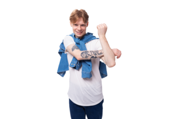 young handsome caucasian man with golden red hair with a tattoo on his arms is dressed in a white t-shirt