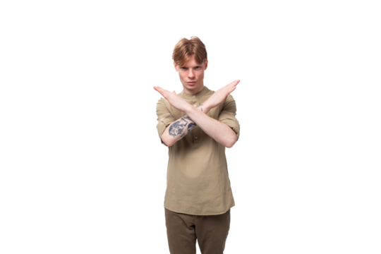 a young European man with red golden hair dressed in a light brown shirt gesticulates on a white background. advertising concept
